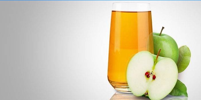 Succo di mela in un bicchiere e mele
