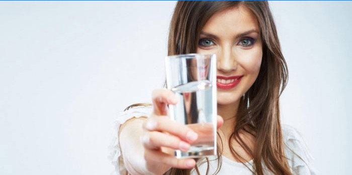 Ragazza con un bicchiere d'acqua in mano