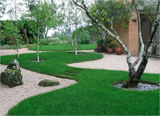 Paesaggio di una casa di campagna: erba verde e un sentiero di piccole pietre Opzioni paesaggistiche per una casa di campagna: erba verde e un sentiero di piccole pietre